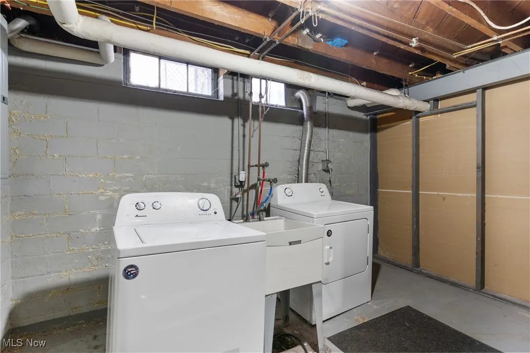 Laundry room with concrete floors and washer and dryer
