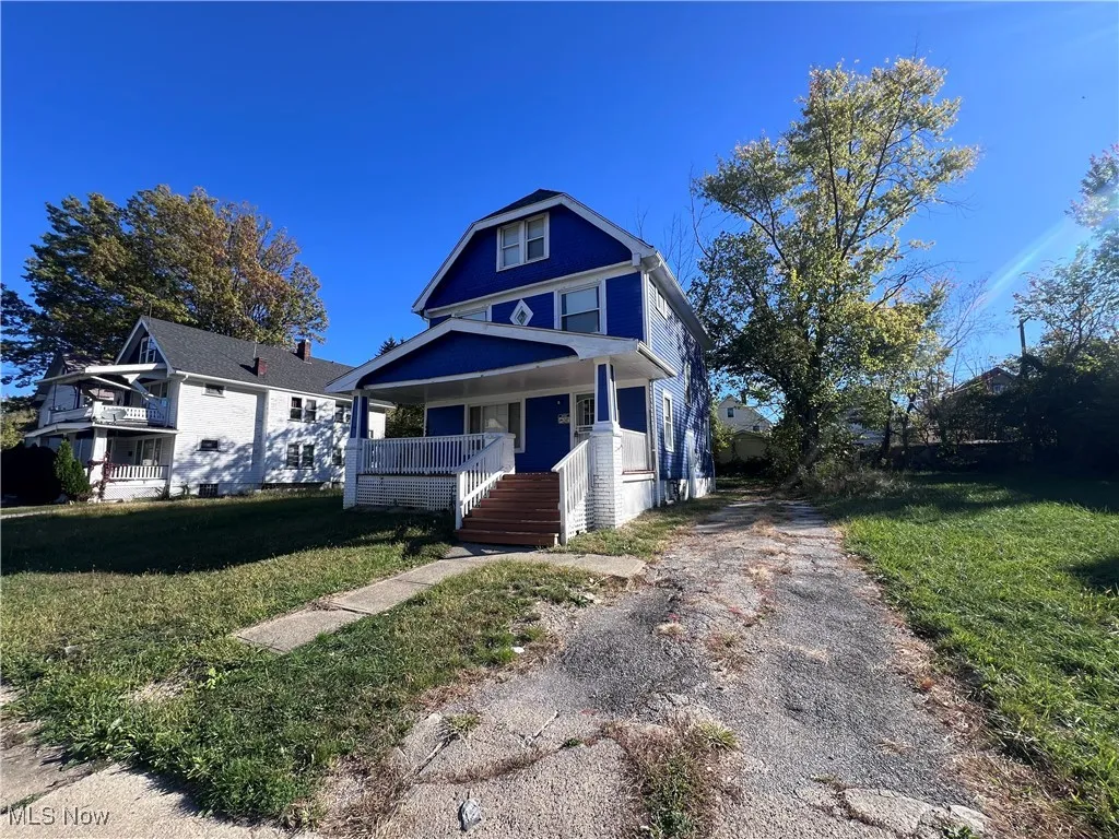 View of front of house with a front yard and a porch