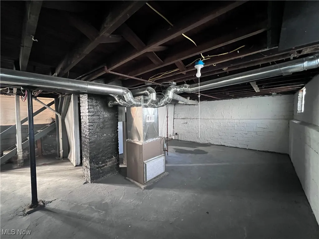 Basement featuring heating unit