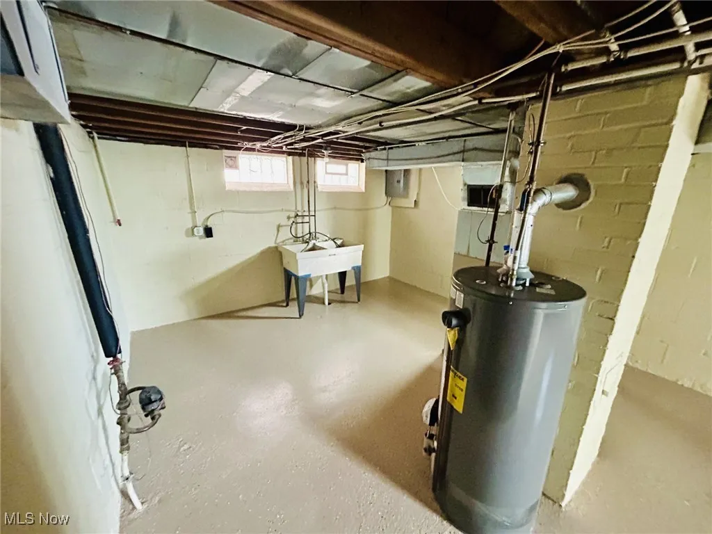 Below grade area with gas water heater and electric panel