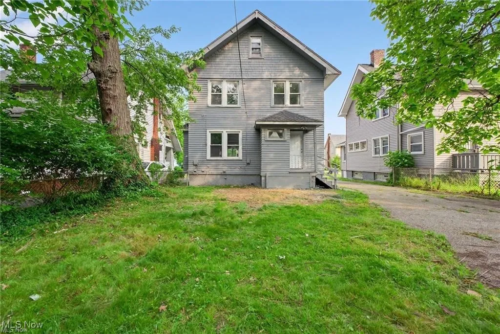 Back of house with a lawn