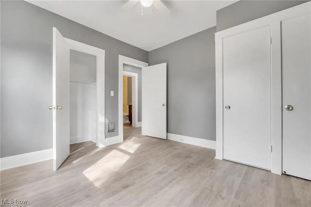 Unfurnished bedroom with light wood finished floors and a ceiling fan