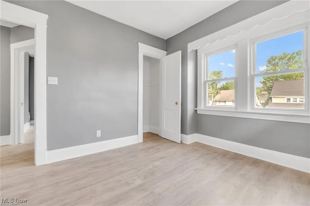 Unfurnished bedroom with light wood-type flooring and a closet