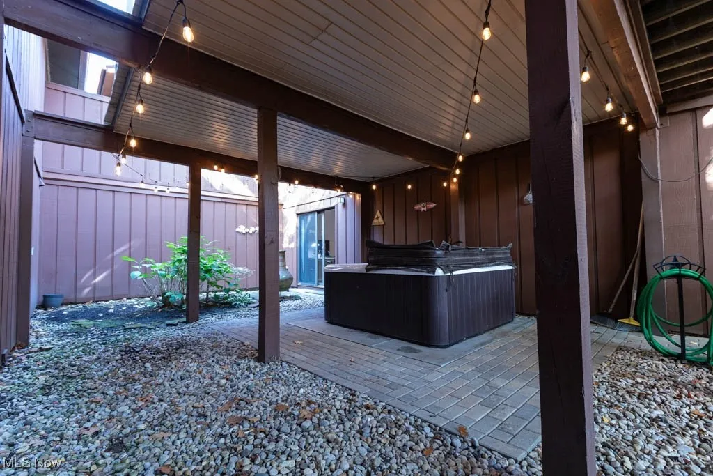 View of patio featuring a hot tub