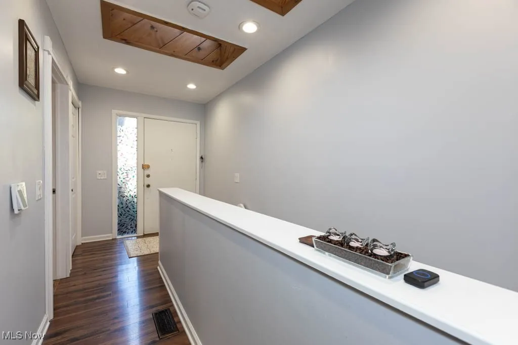 Corridor featuring recessed lighting and dark wood finished floors