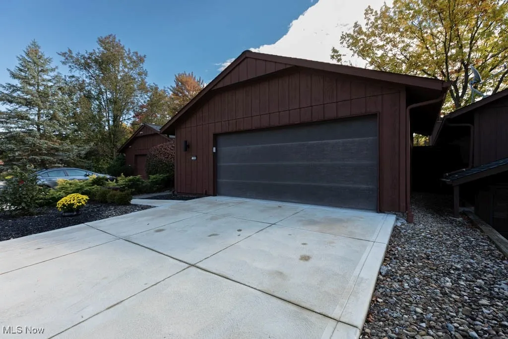 Front of house with garage featuring concrete driveway