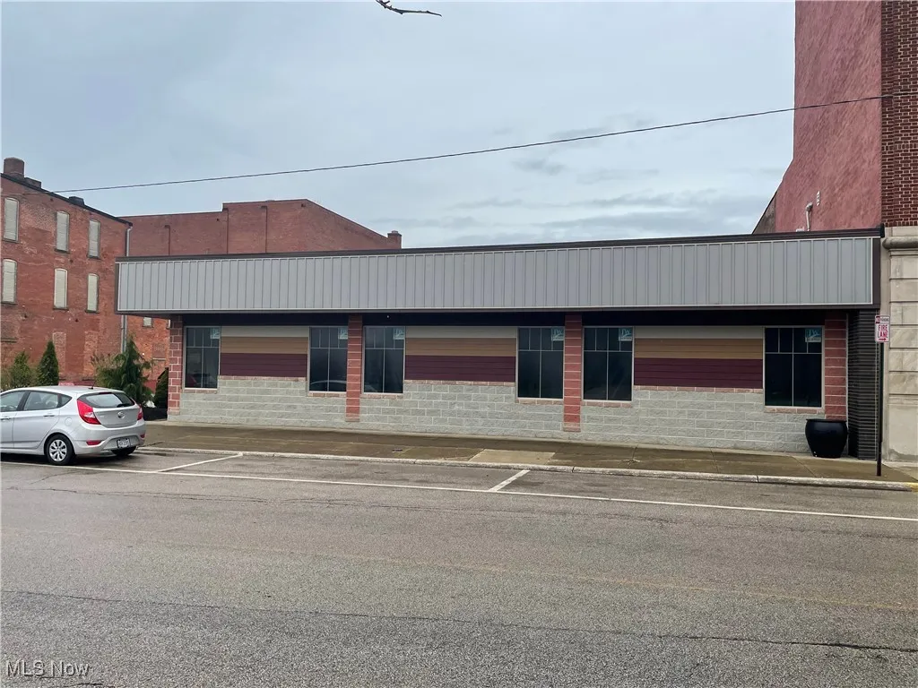 View of property with uncovered parking
