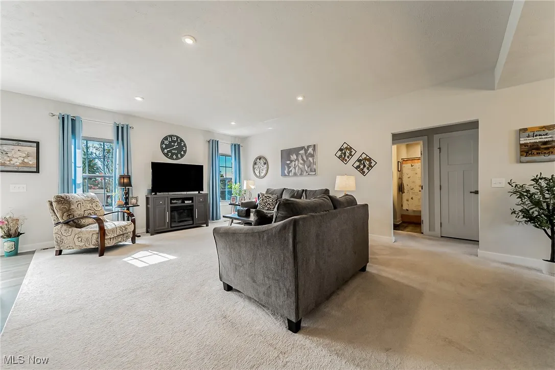 Living room featuring light carpet and recessed lighting
