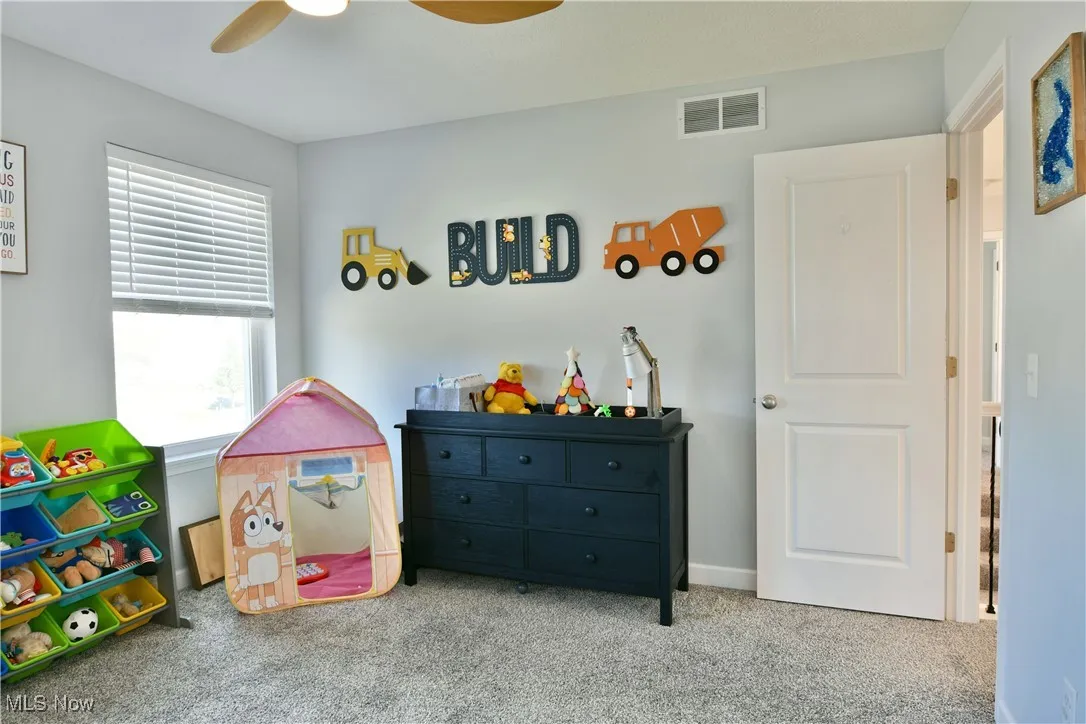 Game room featuring carpet and ceiling fan