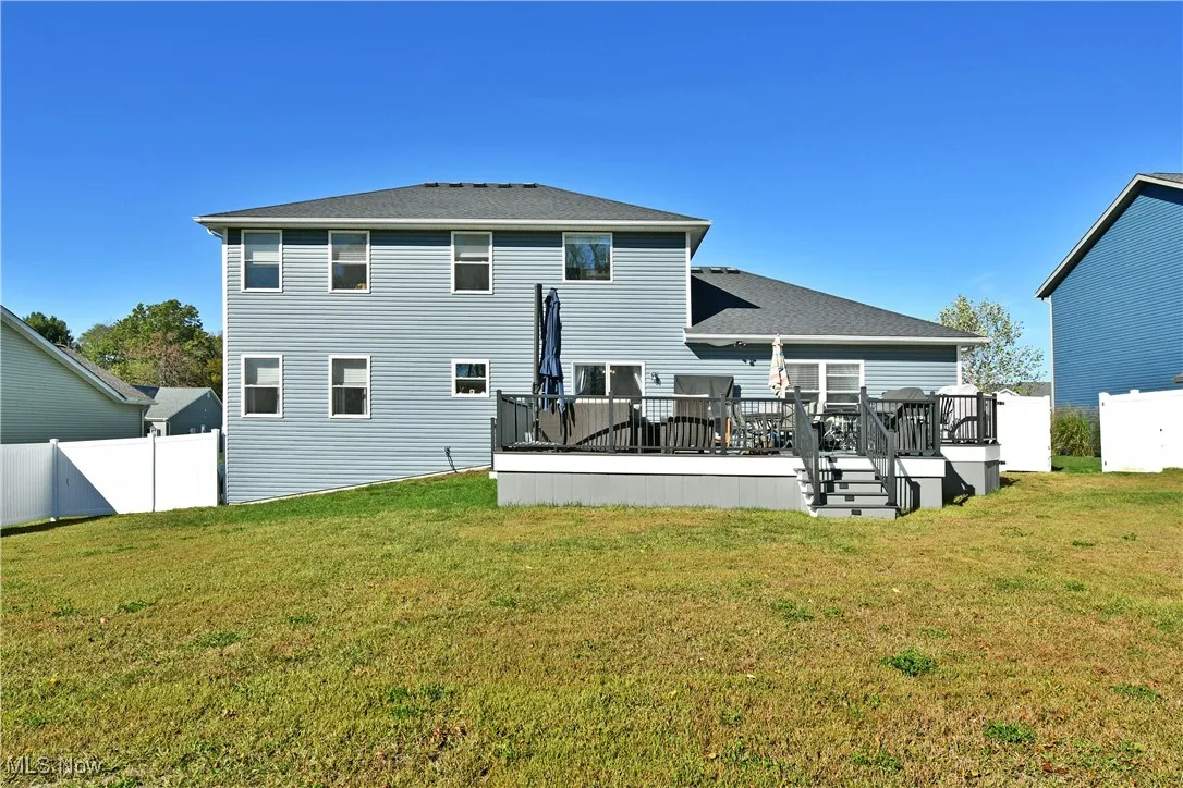 Back of house featuring a wooden deck