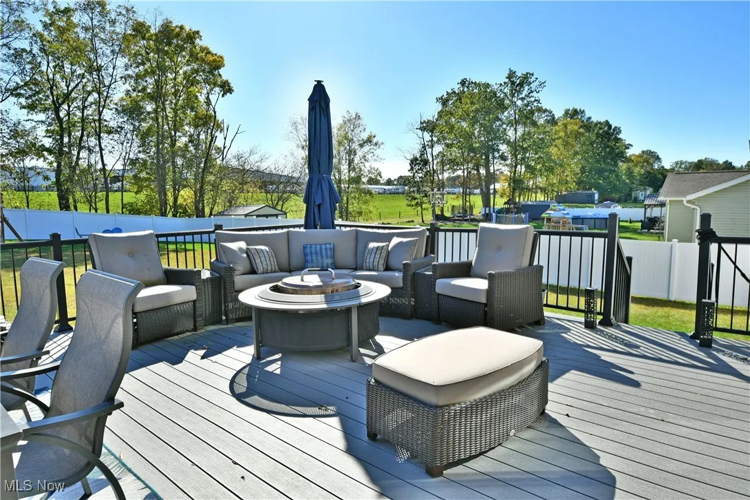 Deck with an outdoor living space with a fire pit