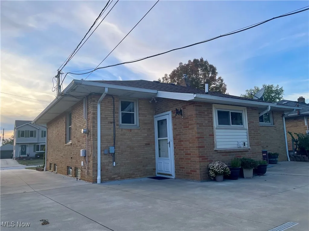 Rear view featuring brick   exterior
