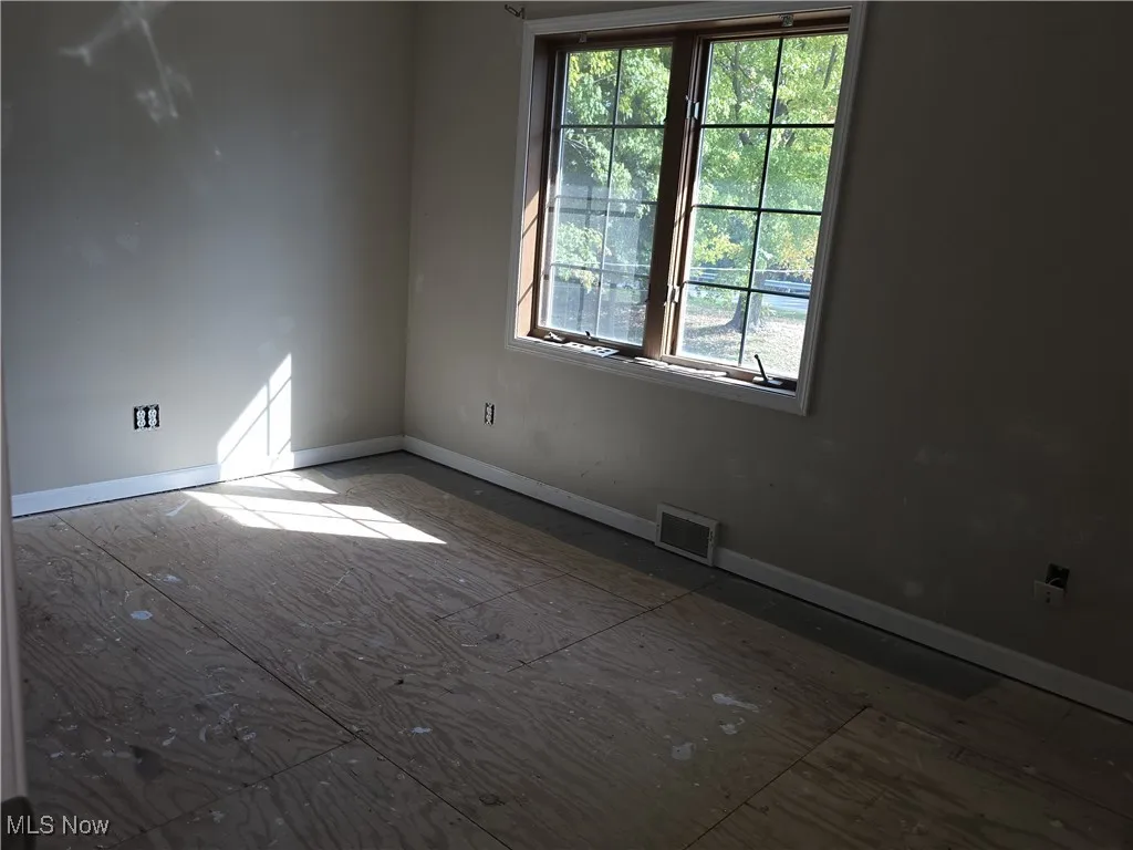 Unfurnished room with baseboards