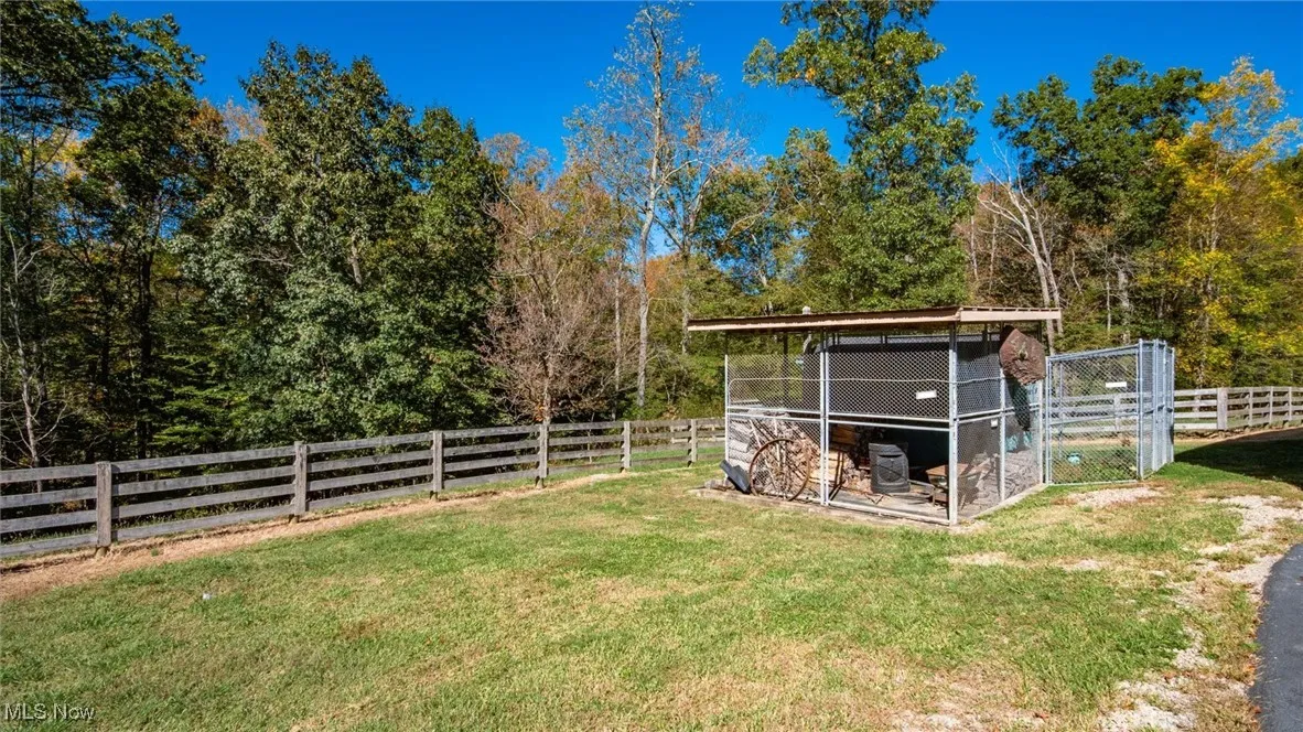 View of yard with an outdoor structure, exterior structure, and a patio