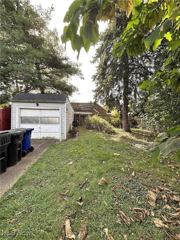 View of yard with an outdoor structure and a detached garage