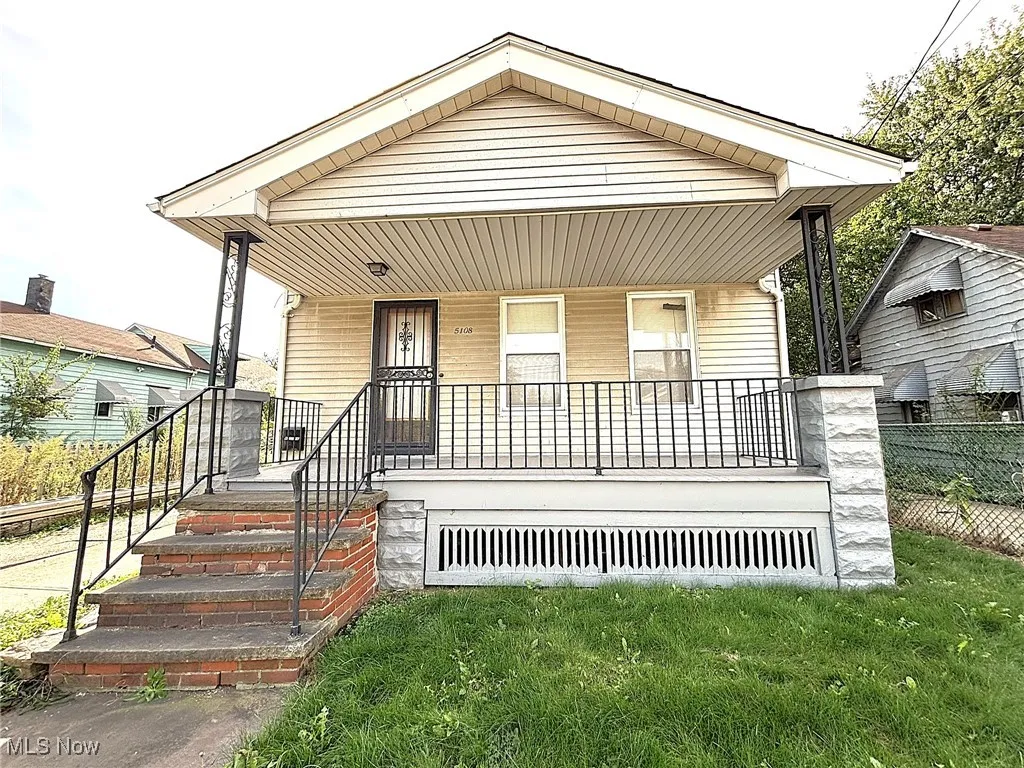 View of front of house featuring covered porch and a front lawn