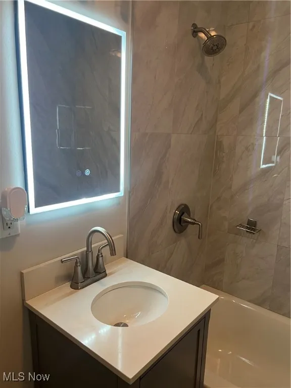 Full bath with vanity and shower / tub combination