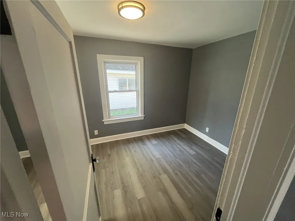 Unfurnished bedroom with light wood-type flooring and baseboards