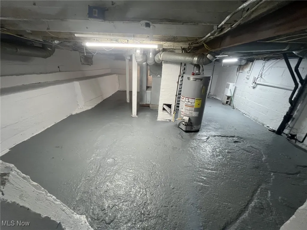 Unfinished basement with water heater and heating unit