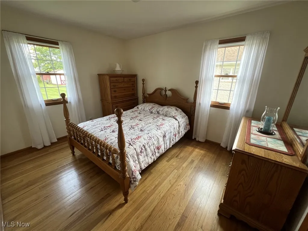 Bedroom with wood-type flooring