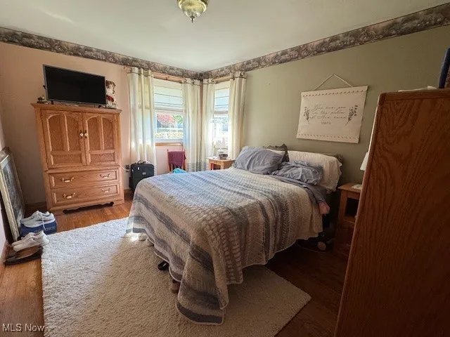 Bedroom with wood finished floors
