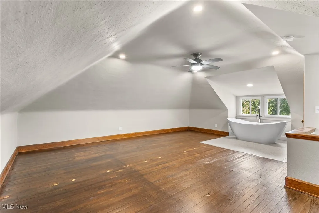 Additional living space featuring lofted ceiling, hardwood / wood-style flooring, a textured ceiling, ceiling fan, and recessed lighting