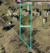 Aerial map of property and surrounding area featuring property parcel outlined