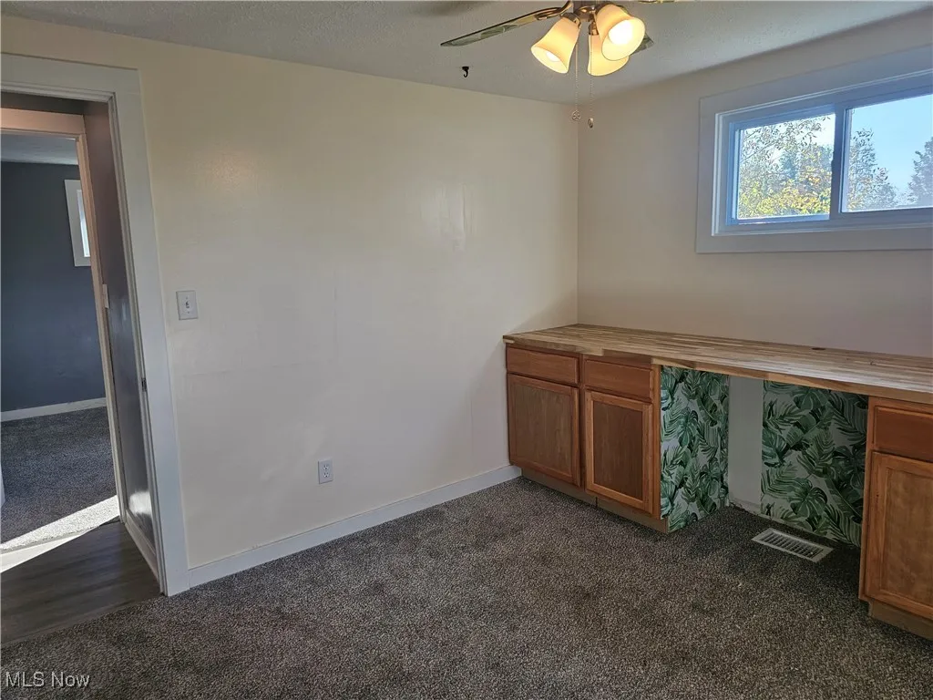 4th bedroom/office or craft room with a ceiling fan.  There is a closet behind the wall at the end of the counter that could be opened up from either bedroom.