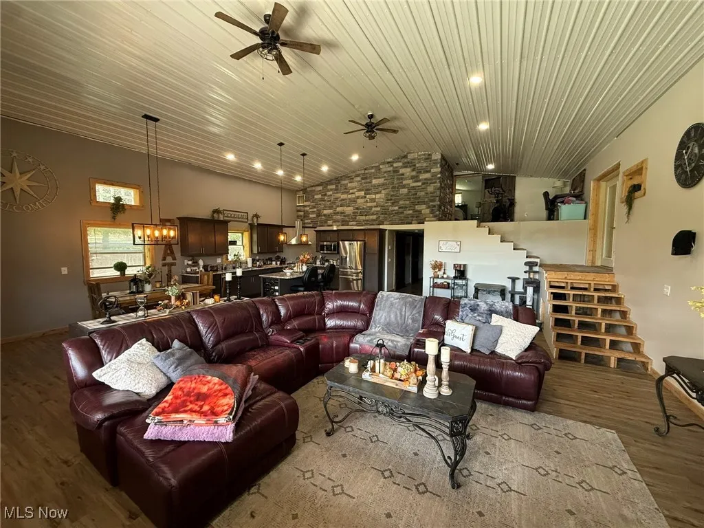 Living area with wood finished floors, ceiling fan, stairway, wood ceiling, and recessed lighting