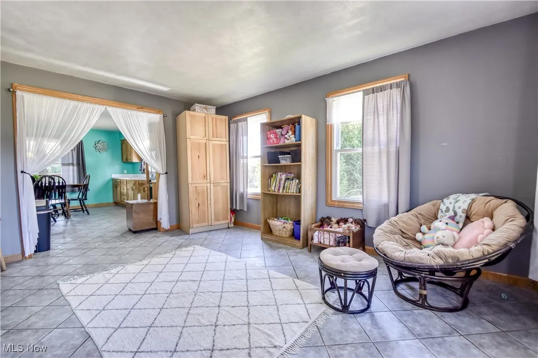 Sitting room with light tile patterned floors and baseboards