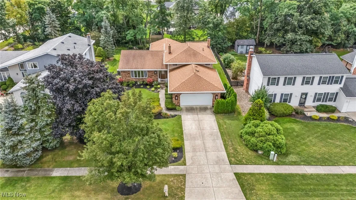 Aerial view of residential area featuring a tree filled landscape