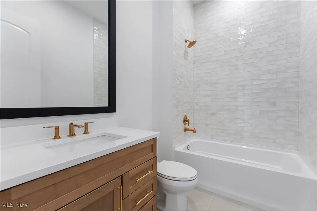 Full bathroom with vanity, shower / washtub combination, and light tile patterned flooring