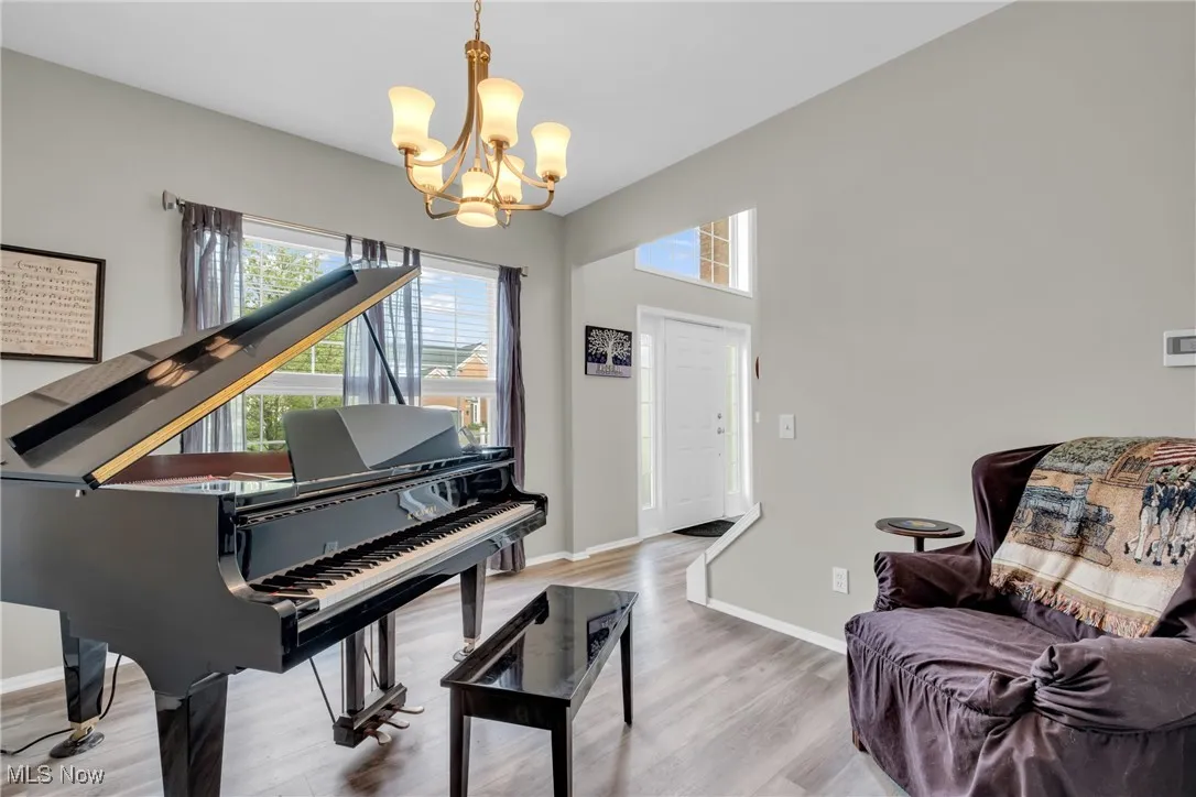 Sitting room featuring wood finished floors and a chandelier