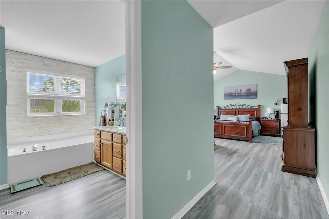 Hallway featuring light wood-style floors and baseboards