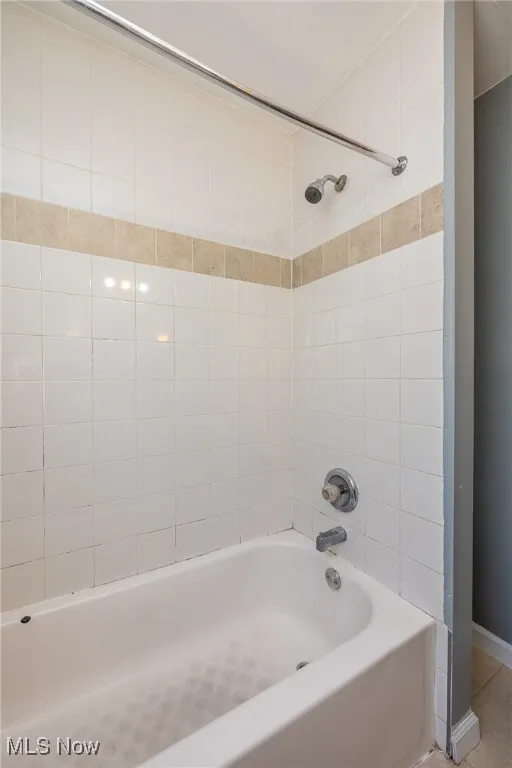 Bathroom featuring bathtub / shower combination and tile patterned floors