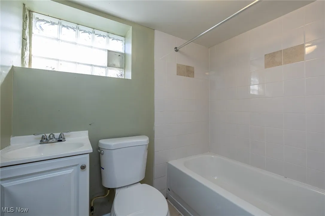 Full bath featuring washtub / shower combination and vanity