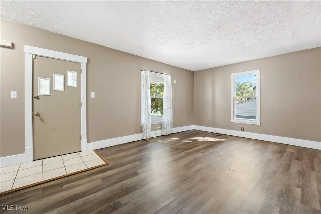 Entrance foyer with a textured ceiling and wood finished floors