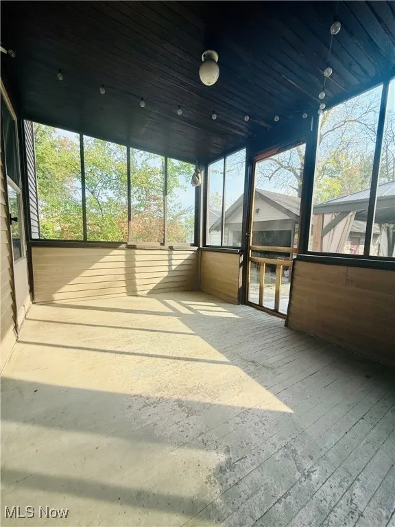 Unfurnished sunroom featuring plenty of natural light