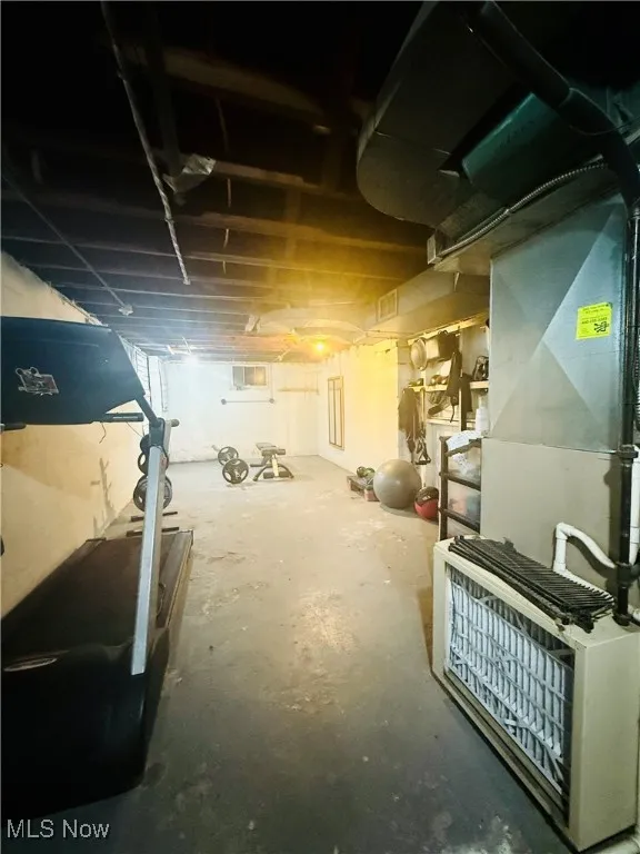 Unfinished below grade area featuring heating unit