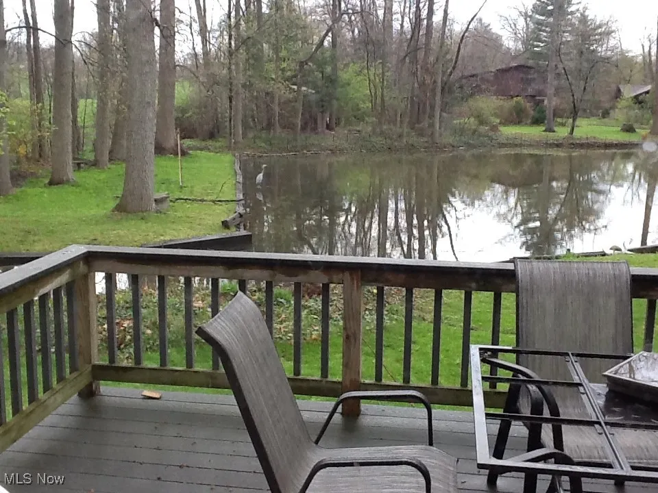 Wooden deck with a lawn and a water view