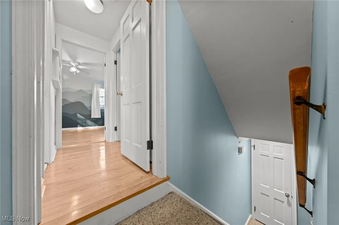 Staircase with ceiling fan and baseboards