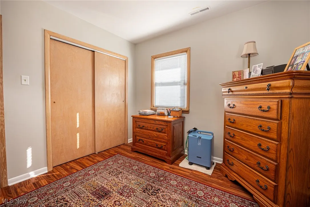 Bedroom with a closet and wood finished floors
