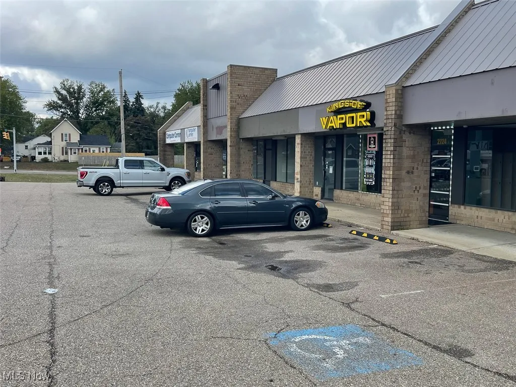 View of building exterior with uncovered parking