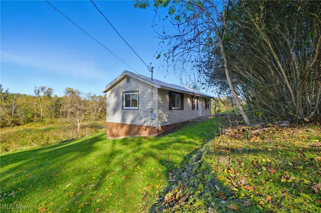 View of property exterior featuring a yard