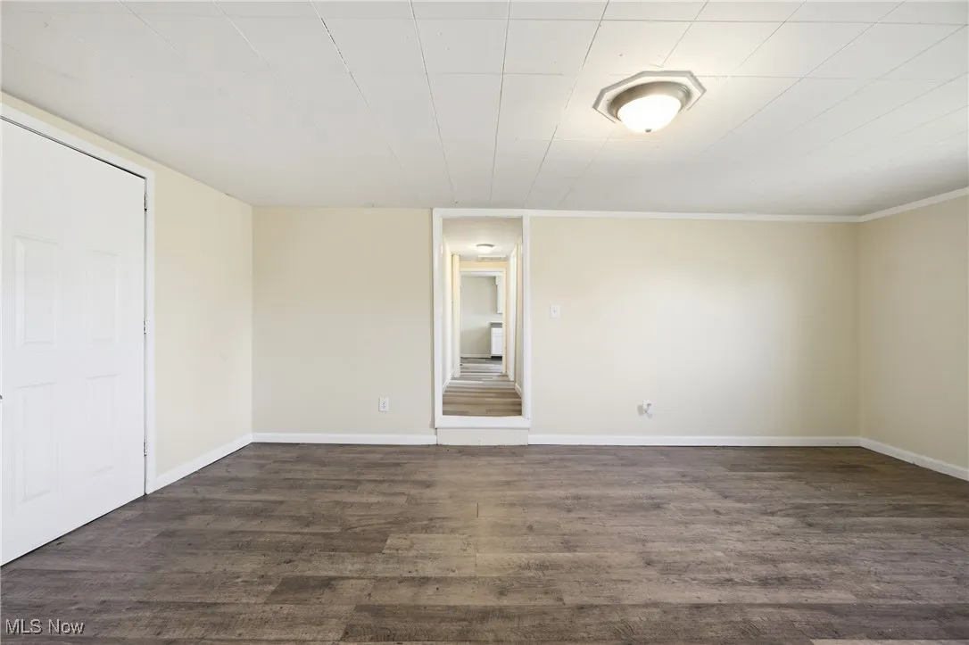 Unfurnished room with dark wood-style floors