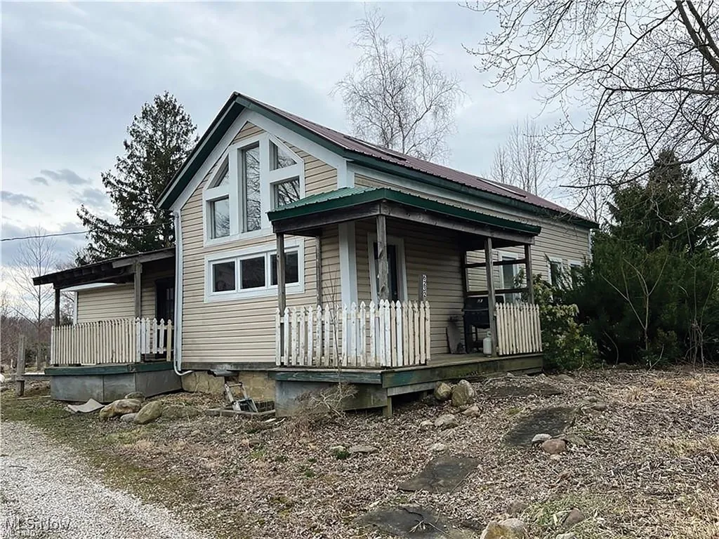View of front of home featuring a porch and a metal roof