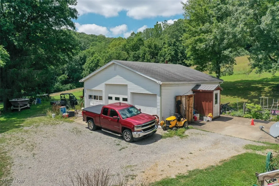 Detached garage featuring a forest view