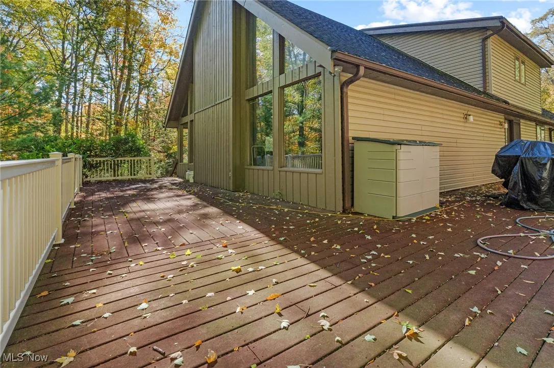 Wooden terrace featuring a grill
