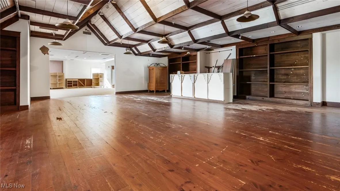 Unfurnished living room featuring hardwood / wood-style floors and wood ceiling