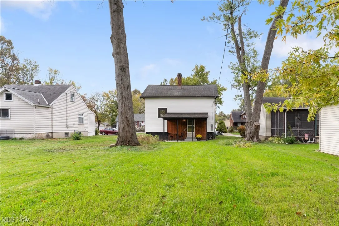 Back of property featuring a yard and a chimney